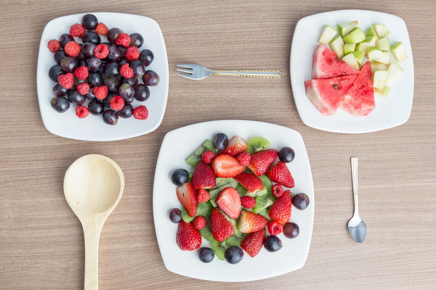 Et bord med tallerkener med frukt og bær