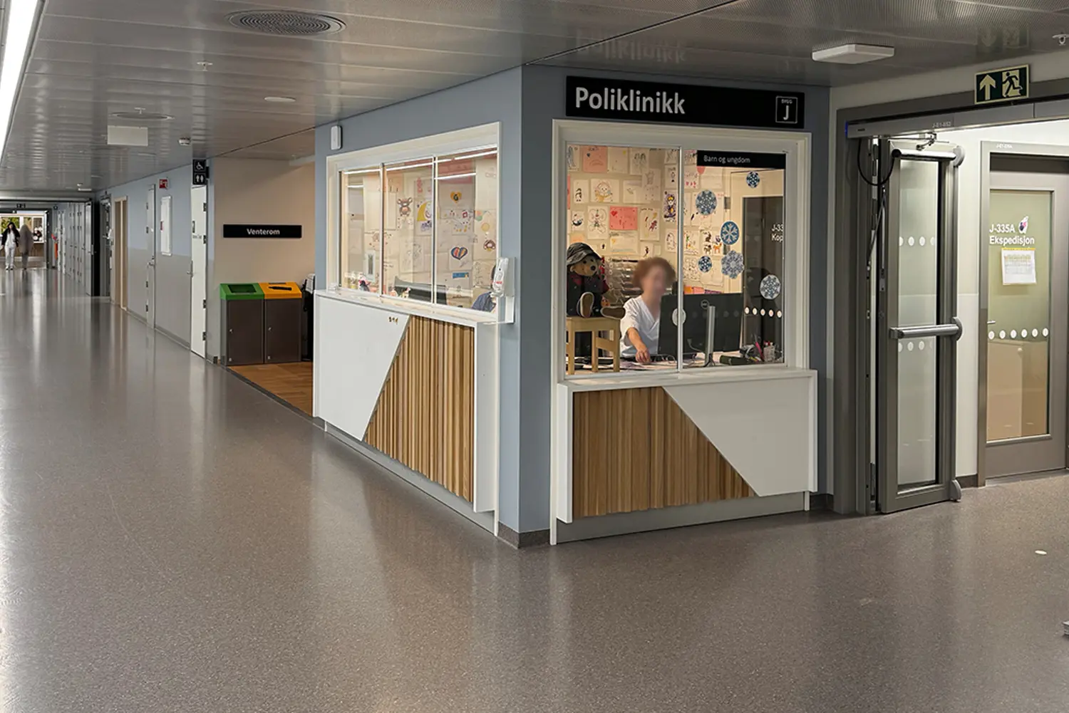 A person sitting at a counter in a room with several doors