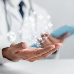 A hand holding a clear glass