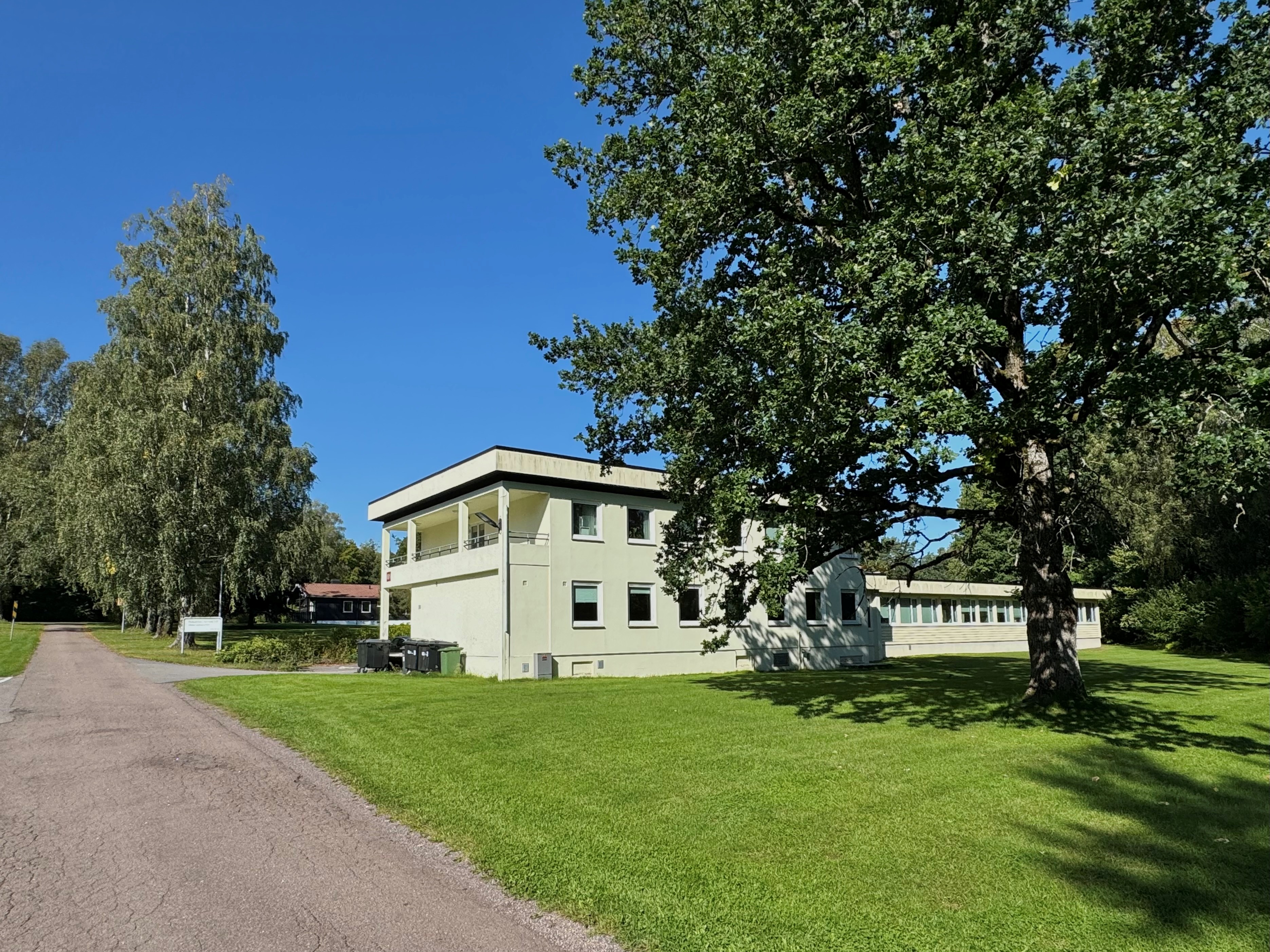 En bygning med trær og gress rundt