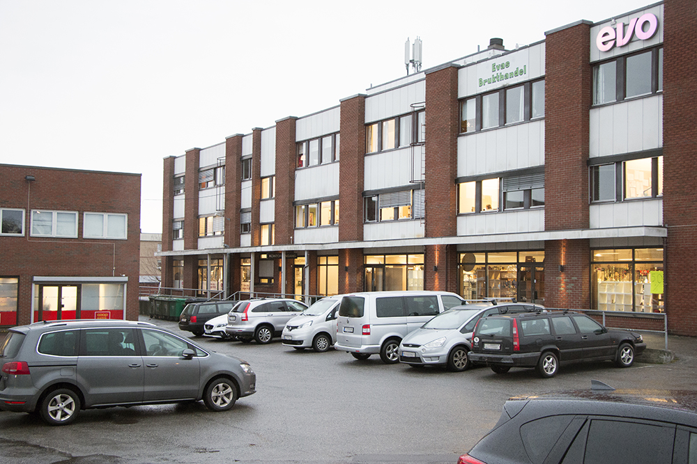 A parking lot in front of a building